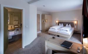 a hotel room with a bed and a bathroom at Hotel-Restaurant Birkenhof in Bad Soden-Salmünster +67 photos