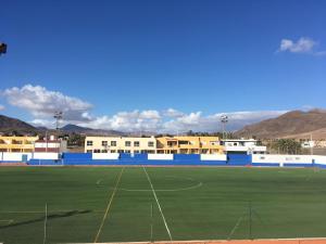 a soccer field with buildings in the background at Tarajalejo Eco C in Tarajalejo