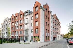 an apartment building with red brick at Happy Stay Tartaczna Residence II in Gdańsk