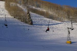 a person skiing down a snow covered ski lift at C1 in Carbondale