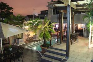 a hotel with a swimming pool and a restaurant at Bon Ami Guest House in Durban