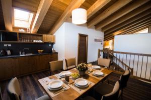 a dining room with a wooden table and chairs at Challet Jasná Exclusive **** in Belá