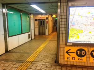 a subway train station with a map on the wall at Namba Guesthouse HIVE in Osaka