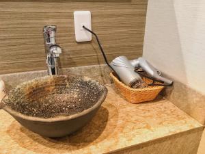 a sink in a bathroom with a faucet at Namba Guesthouse HIVE in Osaka