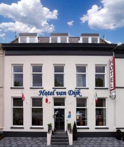 a white building with a hotel van dyke sign on it at Hotel van Dijk in Kampen