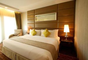 Ein Bett oder Betten in einem Zimmer der Unterkunft Intimate Hotel Pattaya - SHA Extra Plus