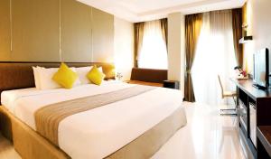 Ein Bett oder Betten in einem Zimmer der Unterkunft Intimate Hotel Pattaya - SHA Extra Plus