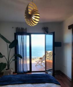 a bedroom with a bed and a view of the beach at La Casa del Risco in El Pinar del Hierro