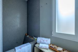 a bathroom with pink towels on a shelf and a window at Attico Terrazza in Venice