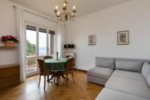 a living room with a table and a couch at Rampolina view by Impero House in Stresa