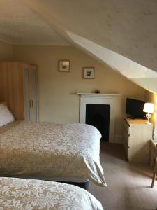 a bedroom with a bed and a fireplace at The Townhouse B and B in Aylesbury