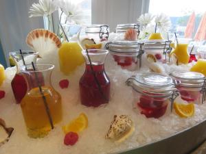 a table withrozen fruit and jars of lemonade and orange juice at The Break Hotel in Narragansett