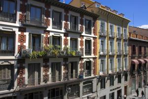 un immeuble avec balcons et fenêtres donnant sur une rue dans l'établissement Carretas Apartments, à Madrid