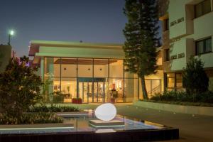 a building with a white sculpture in front of it at C Hotel Neve Ilan in Neve Ilan