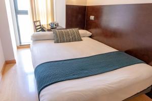Postel nebo postele na pokoji v ubytování Hotel Alda Cardeña