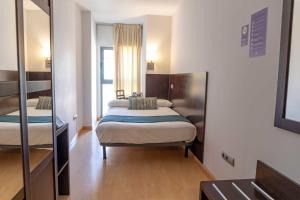 Postel nebo postele na pokoji v ubytování Hotel Alda Cardeña