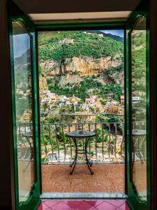 
a view through a glass window of a garden at Villaverde in Positano
