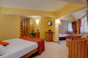 Postel nebo postele na pokoji v ubytování iH Hotels Courmayeur Mont Blanc