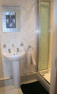 a bathroom with a sink and a shower at Riverside B&B in Cushendall