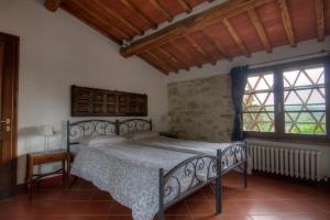 a bedroom with a bed and a large window at Residenzia Del Sogno in Castellina in Chianti