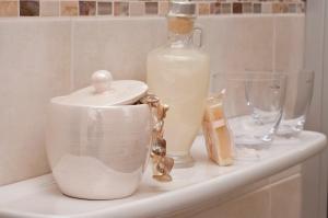a counter with a bottle of milk and other items on it at Pension Weindl in Notzing