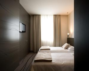 מיטה או מיטות בחדר ב-Eos Hotel
