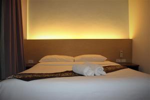 a bedroom with a bed with two towels on it at Freedom Kata in Kata Beach