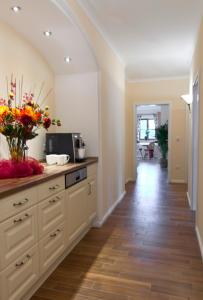 a kitchen with a counter with a vase of flowers at Pension Weindl in Notzing