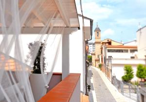 a balcony with a white curtain and a street at Timone 31 in Civitanova Marche