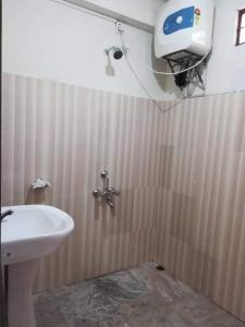 a bathroom with a white sink and a shower at Delight Homestay in Cherrapunji