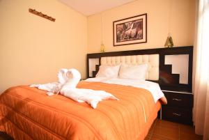 Rúm í herbergi á Tambo Cusco Inn