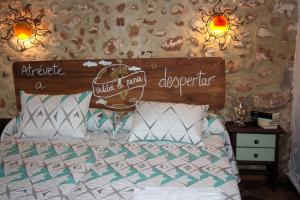 a bedroom with a bed with a sign on it at La Carrihuela in Algodonales