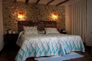 a bedroom with a large bed and a large window at La Carrihuela in Algodonales