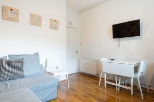 a living room with a couch and a table at Fraser Apartment in Aberdeen