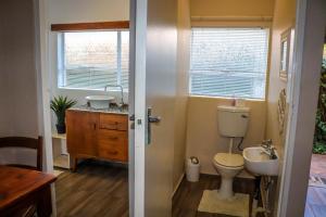 a bathroom with a toilet and a sink at Huys ten Bosch in Potchefstroom +44 photos
