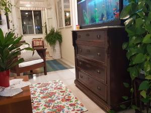a living room with a dresser with a fish tank at Marco's house in Dolianova