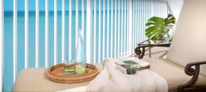 a room with a tray of drinks and a basket of towels at La Playa Beach & Golf Resort, a Noble House Resort in Naples