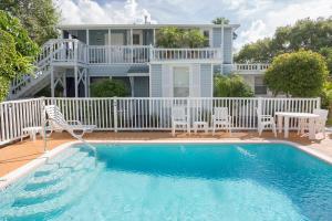 a house with a swimming pool in front of a house at Meranova Guest Inn in Dunedin