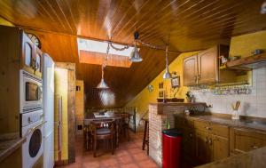 a kitchen with wooden cabinets and a table in it at Casa Las Cadenas in Úbeda