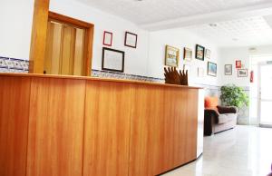 a lobby with a reception desk in a room at Hotel Trabuco in Santiago de la Ribera
