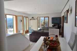 a living room with a couch and a table at Côte d'Azur Villa Amicalement Hôte in Coursegoules