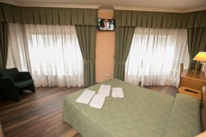 Postel nebo postele na pokoji v ubytování Hotel PAYRO