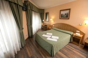 Postel nebo postele na pokoji v ubytování Hotel PAYRO