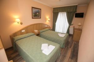 Postel nebo postele na pokoji v ubytování Hotel PAYRO