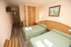 Postel nebo postele na pokoji v ubytování Hotel PAYRO