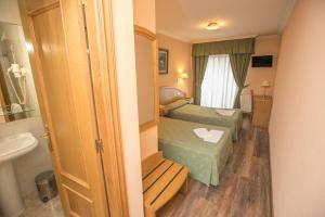 Postel nebo postele na pokoji v ubytování Hotel PAYRO