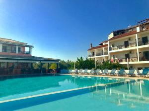 
a hotel room with a pool and a balcony at IONIAN SUITES by Bruskos in Agios Georgios
