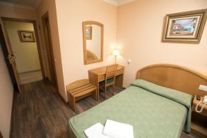 Postel nebo postele na pokoji v ubytování Hotel PAYRO