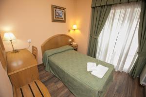 Postel nebo postele na pokoji v ubytování Hotel PAYRO