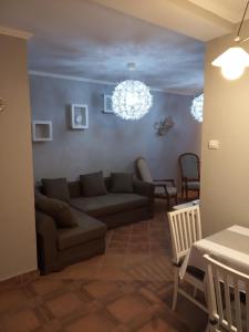 a living room with a couch and a chandelier at Borókahaus in Tata